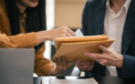 A man and woman reviewing some documents