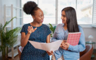 A social worker talking to a younger colleague to symboilse mentoring, coaching or practice education