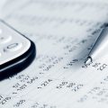 Image of accounts sheet with pen and calculator (credit: Wrangler / Adobe Stock)