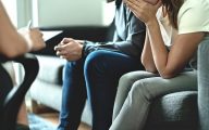 upset parents talking to social worker