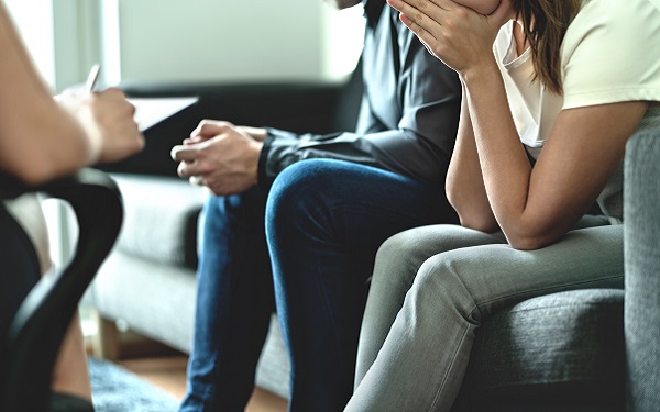 upset parents talking to social worker