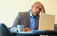 A Black social worker looking downcast