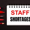 Pad of paper with 'staff shortages' written on it
