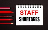 Pad of paper with 'staff shortages' written on it