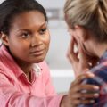 Social worker reassuring a young person