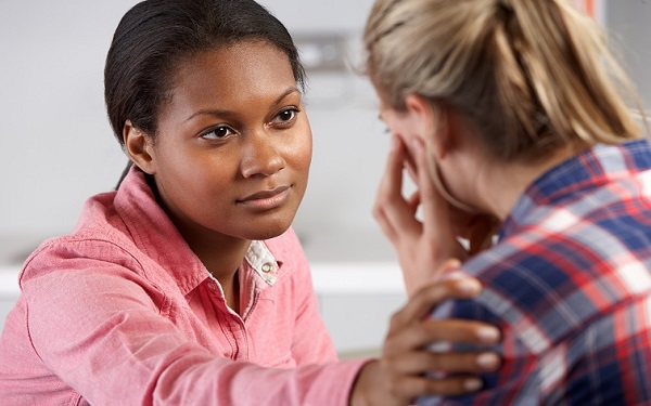 Social worker reassuring a young person