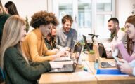 Group of staff laughing together in the office