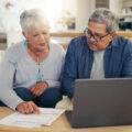 An older couple poring over their finances