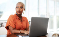 Black woman working in an office looking to the side