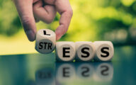 Having less stress or being stress-less. Hand turns a cube and changes the word "STRESS" to "LESS".