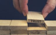 Trust word written on wooden block.