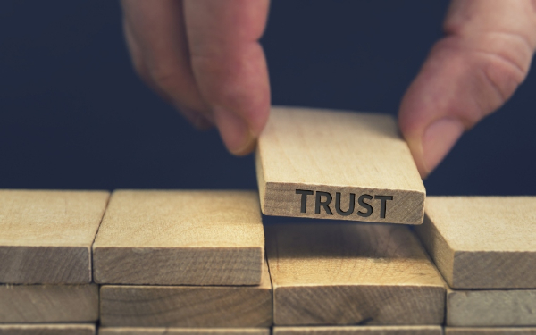 Trust word written on wooden block.