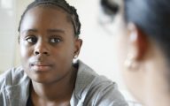 black girl talking to adult woman