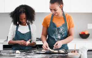 Children's home worker and staff member baking together Children's home worker and staff member baking together