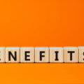 Cubes spelling out the word 'benefits' with a final cube having 'Yes' on one face and 'No' on the other