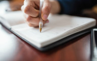 description_of_image_used_in_article_diary_I_manage_a_single_toilet_break_during_my_first_shift_picture_of_someone_writing_in_diary