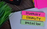 Diversity Equality Inclusion write on a sticky note isolated on Office Desk.