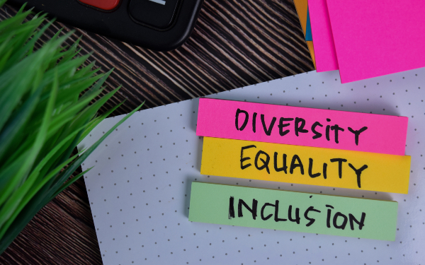 Diversity Equality Inclusion write on a sticky note isolated on Office Desk.