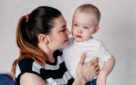 crying toddler being comforted by mother