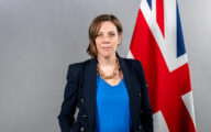 Jess Phillips, the minister for safeguarding and violence against women and girls, standing in front of a Union flag