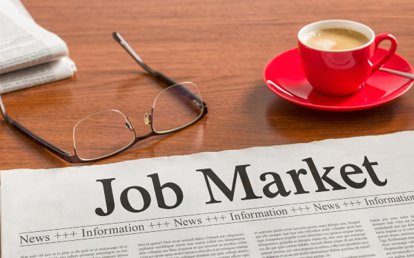 A newspaper on a wooden desk - Job Market