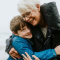 Happy grandmother hugging her grandson