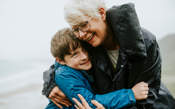 Happy grandmother hugging her grandson