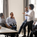 Group of colleagues talking together in an office