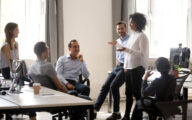 Group of colleagues talking together in an office