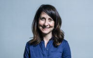 Liz Kendall, smiling, wearing a blue shirt
