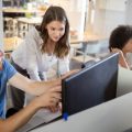 Manager and social worker talking about work over a computer