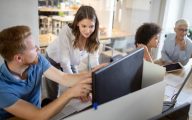 Manager and social worker talking about work over a computer