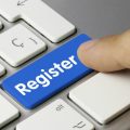 Person pushing register key on keyboard