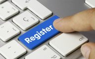 Person pushing register key on keyboard