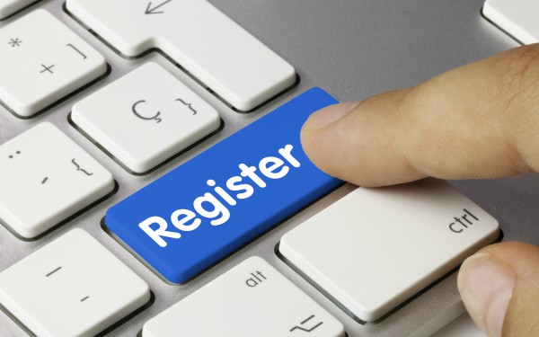 Person pushing register key on keyboard