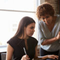 A practice educator or social work manager talking to a student