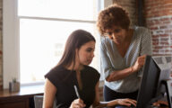 A practice educator or social work manager talking to a student