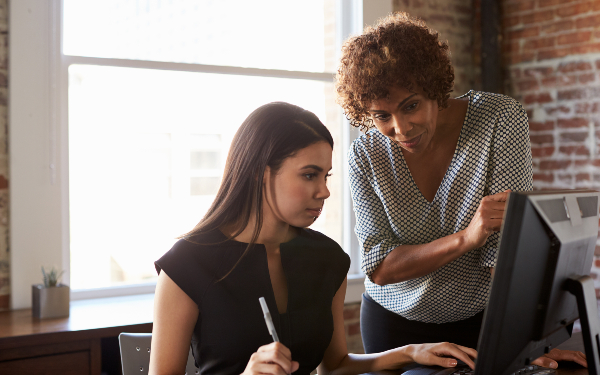 A practice educator or social work manager talking to a student