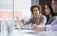 Three social workers discussing a case in their office