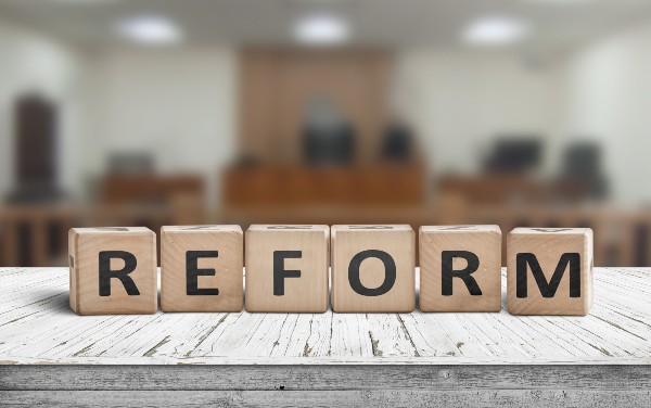 Reform sign on a desk with a blurry background of a court room