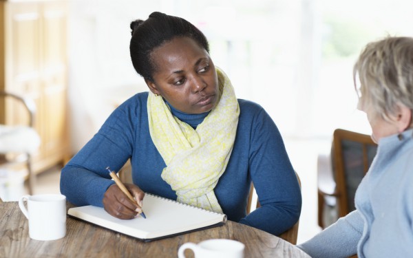Social worker assessing older woman