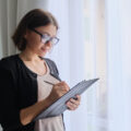 Social worker making notes looking satisfied