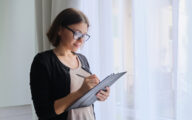 Social worker making notes looking satisfied