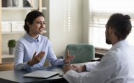 Social worker talking to doctor