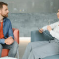 Social worker assessing/conducting therapeutic intervention with man