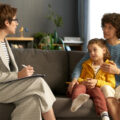 Social worker with kinship carer or adoptive parent and child
