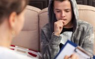 Social worker counselling young man