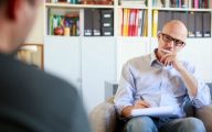 Therapy session, adult man talking to his psychotherapist