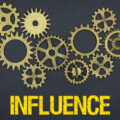 The word influence in yellow below a series of cogs against a black background