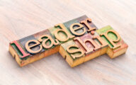 The word 'leadership' spelt out on a wooden letterpress sat on a table